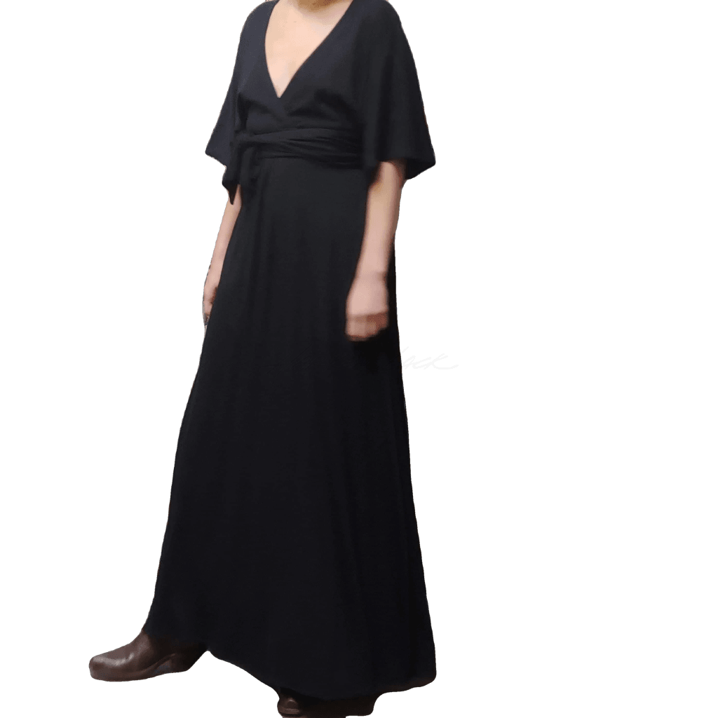 Model wearing McCULLOUGH Carnaby Maxi dress in black knit jersey with matching waist tie. At Harkensback.