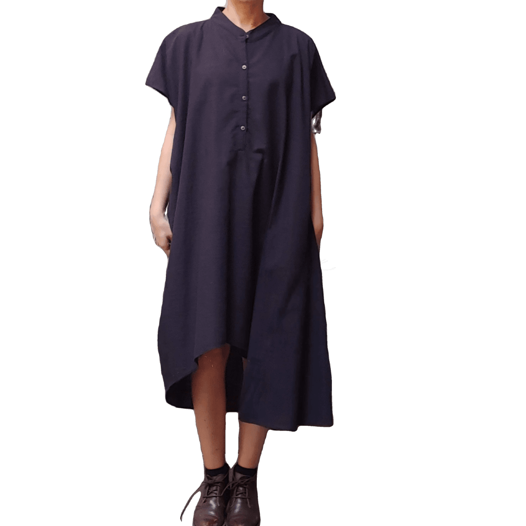 Model in McCULLOUGH Geode Henley Dress in black cotton at Harkensback.