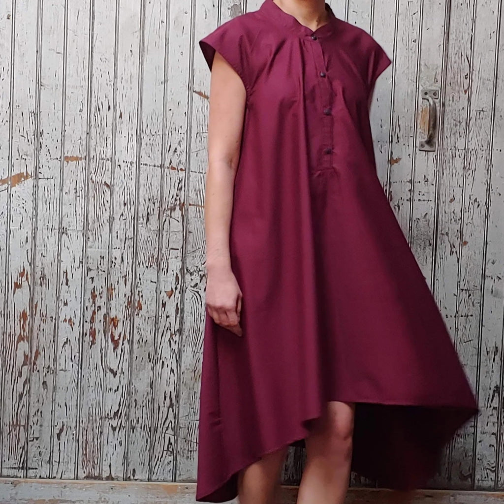 Minamalist Fashion Sustainable Production Model wearing McCULLOUGH button down Rambla swing dress in merlot poplin cotton at Harkensback. Features nehru collar.