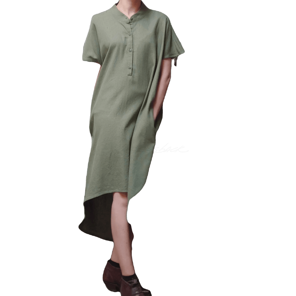 Model in McCULLOUGH High Low Henley Tunic in olive linen. Hand in pocket and model twisting slightly to show fabric movement.
