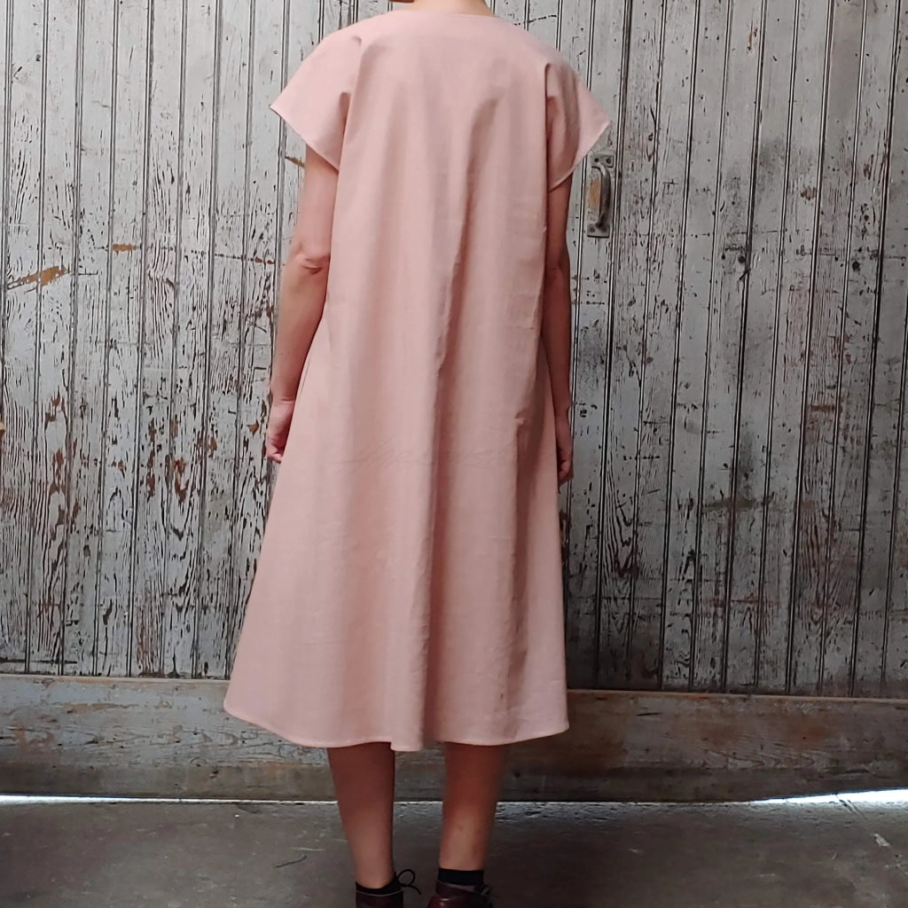 Back view of model wearing McCULLOUGH Morian Midi swing dress in rose linen at Harkensback.