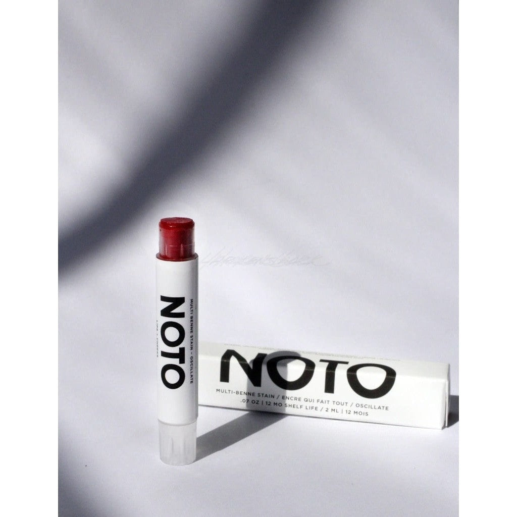Brilliant red colored NOTO Oscillate Multi-Benne Stain Stick displayed next to white product box with black lettering.