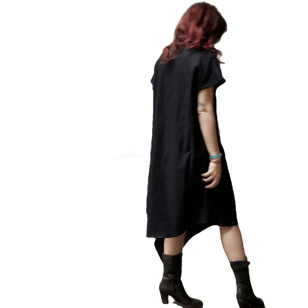 Partial back view of model in McCULLOUGH Short Sleeve Asymmetric Henley Tunic in black poplin cotton at Harkensback.