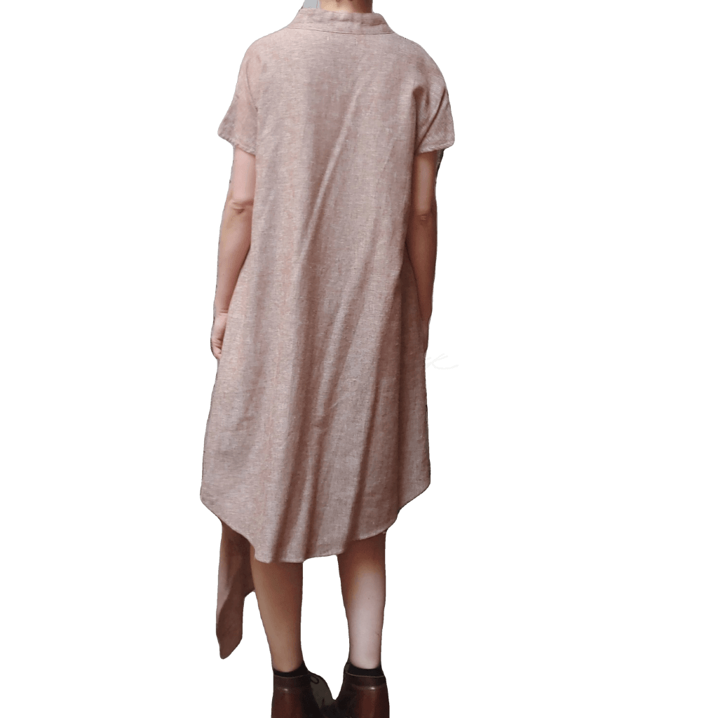 Back view of model in McCULLOUGH Short Sleeve Asymmetric Henley Tunic in rose linen at Harkensback.